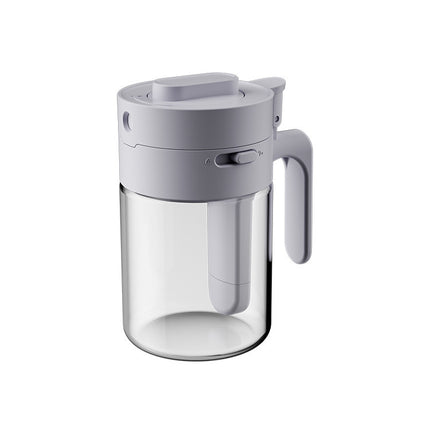 Clear glass pitcher with gray lid and handle on a white background