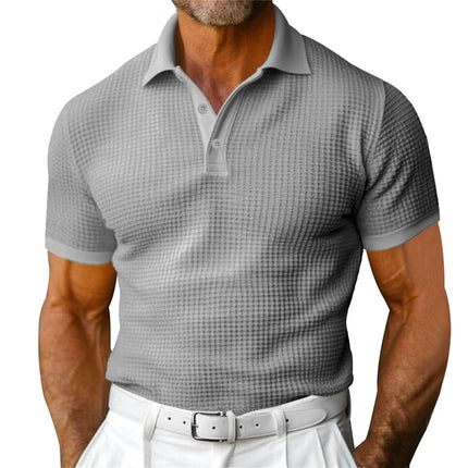 Man wearing a gray checkered polo shirt and white pants on a white background