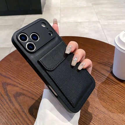 Black phone case with card holder held by a hand on a wooden table.