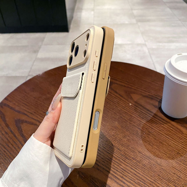 Phone case with a card holder held by a hand on a wooden table.