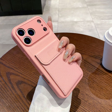 Pink phone case held by a hand on a wooden table with a blurred background